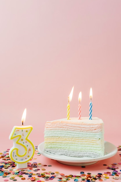 Free photo birthday cake with lit candles