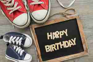 Free photo birthday composition with slate and shoes