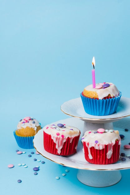 Birthday cupcakes arrangement on blue background