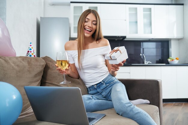 Birthday lady having video call on laptop at home