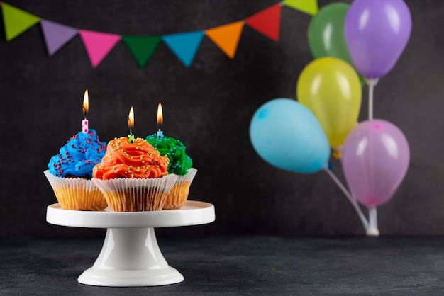 Birthday party cupcakes with colorful balloons