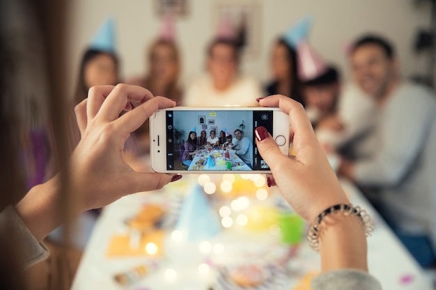 Free Photo birthday party through smartphone screen