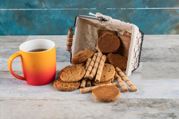 A biscuit box with a cup of tea