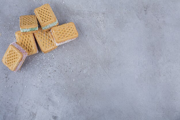 Biscuit sandwich filled with colorful marmalade on stone.