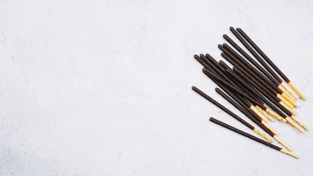 Biscuit sticks in chocolate on white backdrop