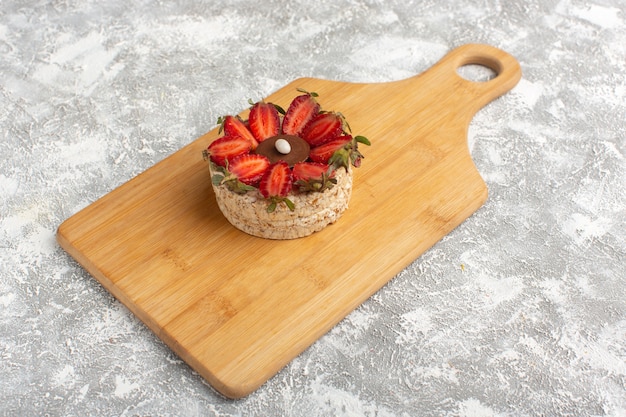 biscuit with strawberries on wooden desk