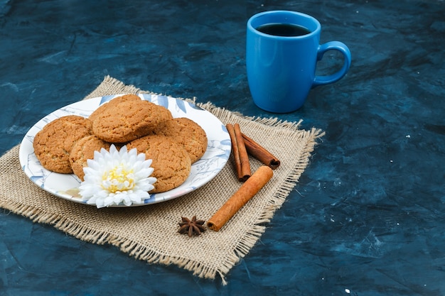 Biscuits and coffee cup on a dark blue background