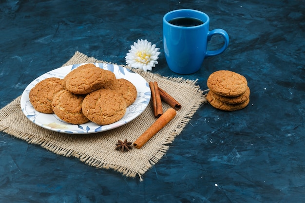 Biscuits and coffee cup on a dark blue background