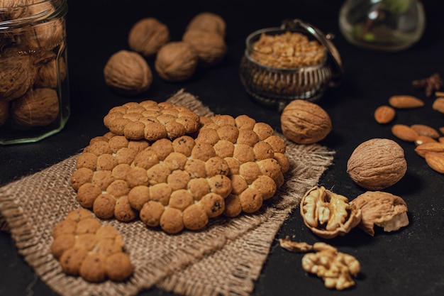 Biscuits and nuts on black surface