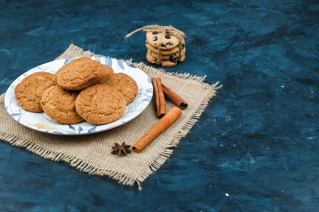 Biscuits on a plate with spices, cinnamon sticks