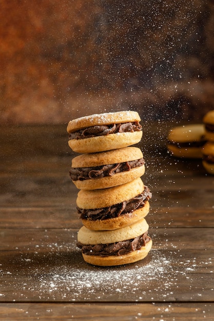 Biscuits with cream on wooden table