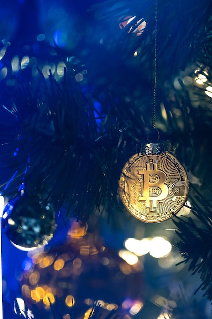 Free Photo bitcoin coin on christmas tree with bokeh lights finance concept