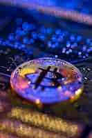 Free photo bitcoin coin closeup on circuit board finance concept