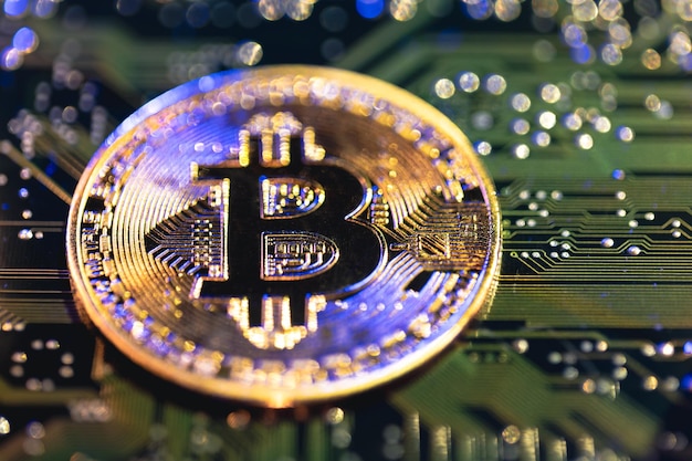 Free photo bitcoin coin closeup on circuit board finance concept