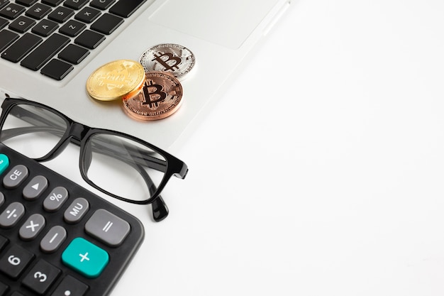 Free photo bitcoin sitting on laptop with copy-space