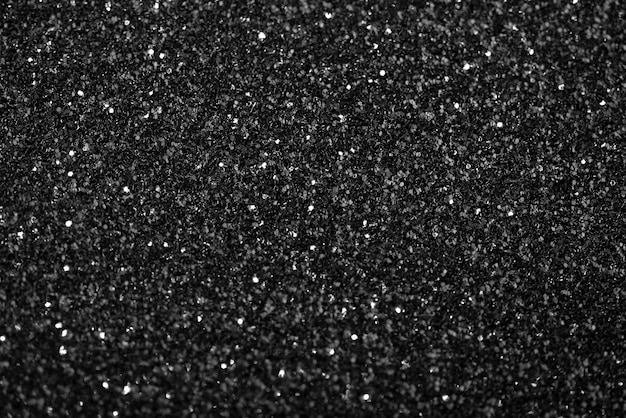 Free Photo black background with defocused glitter