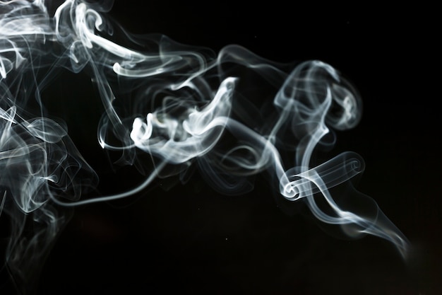 Free Photo black background with delicate smoke silhouette