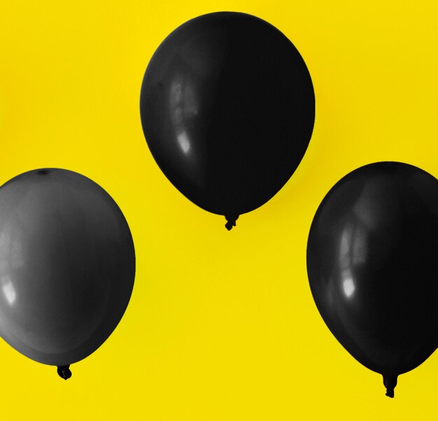 Black balloons on yellow background