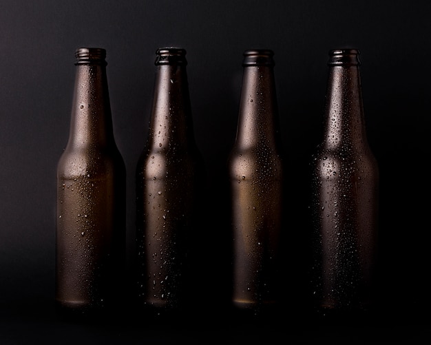 Free Photo black beer bottles line