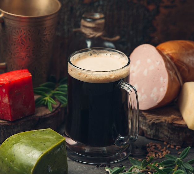 black beer with green cheese on the table