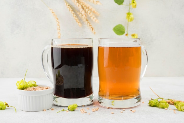 Free photo black and blonde beer with wheat seeds