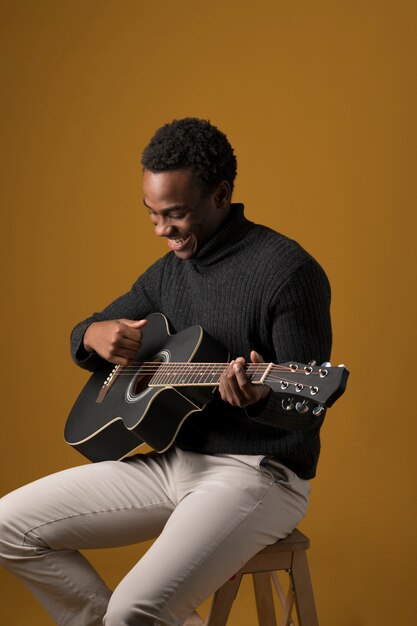 Free Photo black boy playing the guitar