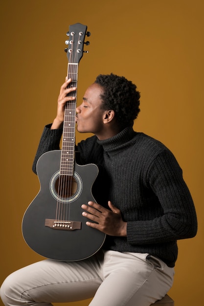 Black boy playing the guitar