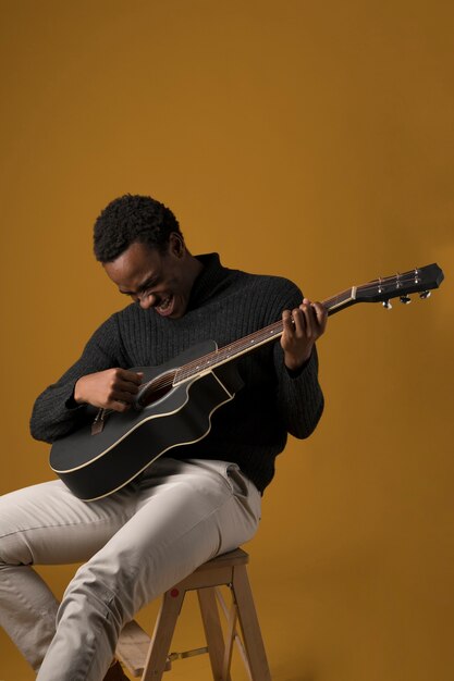 Black boy playing the guitar