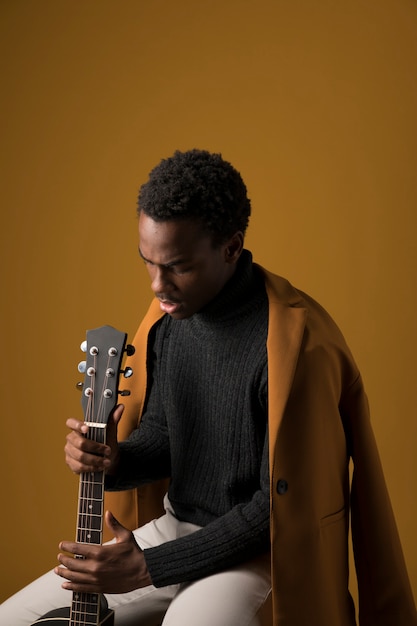 Free Photo black boy playing the guitar