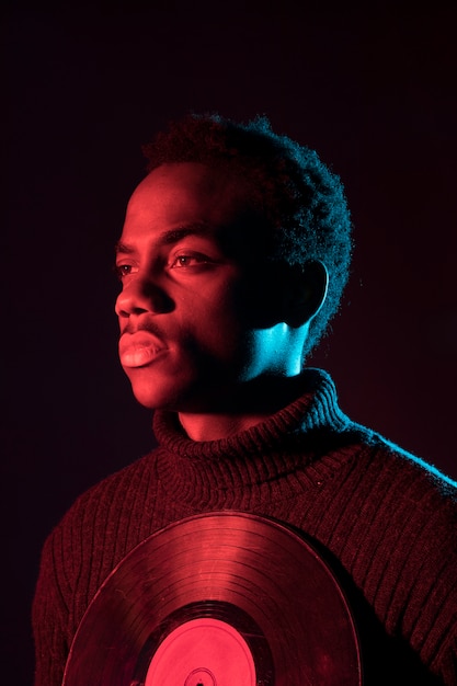 Free photo black boy posing with vinyls