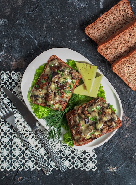 Free Photo black bread sandwiches with mushroom salad