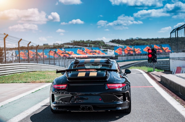 Black cabriolet sport sedan car with two yellow stripes,