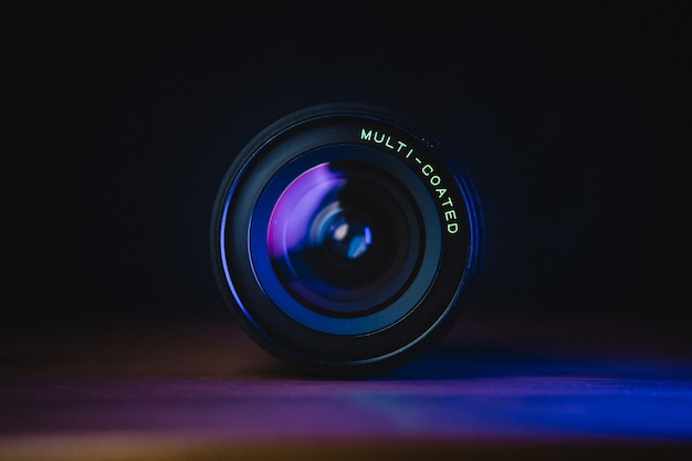 Free Photo black camera lens on blue surface