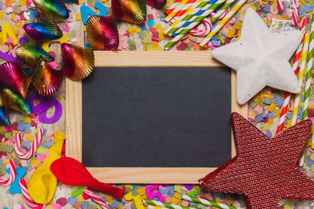 Black chalkboard with party decoration with balloons and confetti