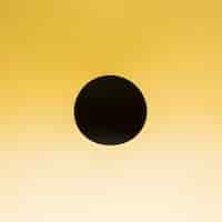 Free photo black circle on a gradient yellow background