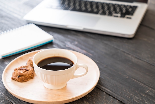 Free Photo black coffee and cookies with laptop and note book