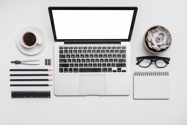 Black coffee; laptop; succulent plant and office supplies isolated on white background