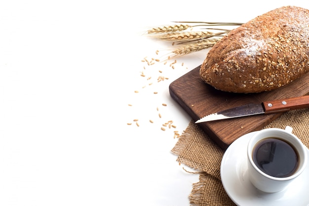 Black coffee and whole wheat bread for breakfast on white background