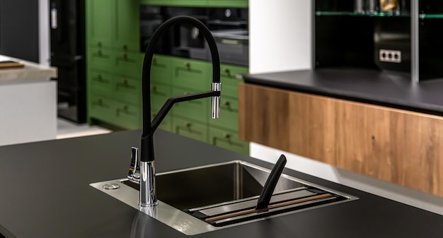 Free Photo black faucet with a steel sink in a stylish modern kitchen