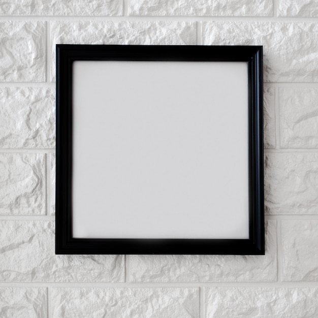 Black frame on white brick wall