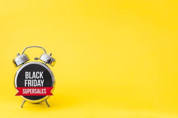 Black friday alarm on yellow background