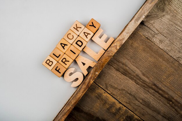 Black friday cubes on plain and wooden background