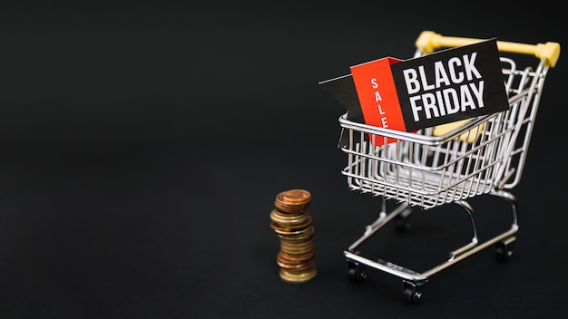 Free Photo black friday decoration with coins and cart