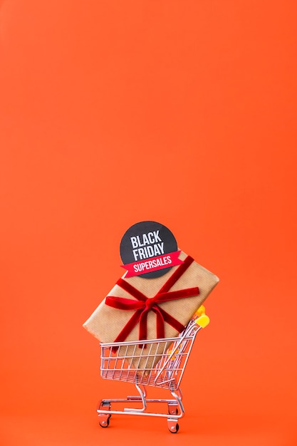 Free photo black friday decoration with label on gift box in cart