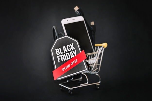 Free photo black friday decoration with smartphone in cart and label