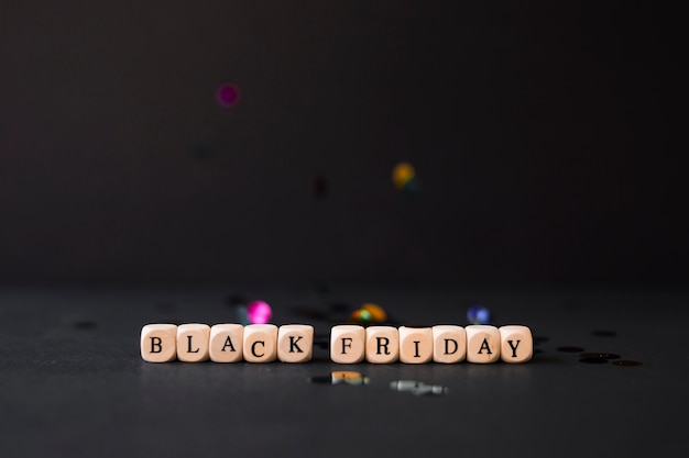 Free photo black friday inscription on cubes with confetti