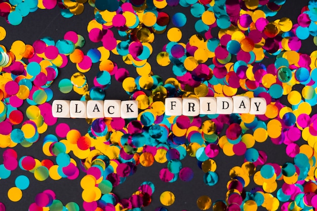 Black Friday inscription on cubes with confetti