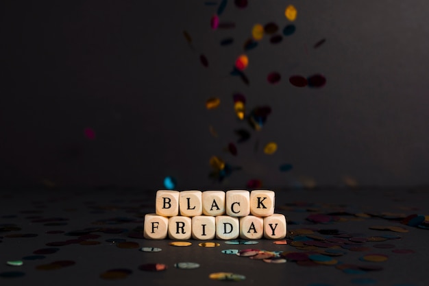 Free photo black friday inscription on cubes with falling confetti