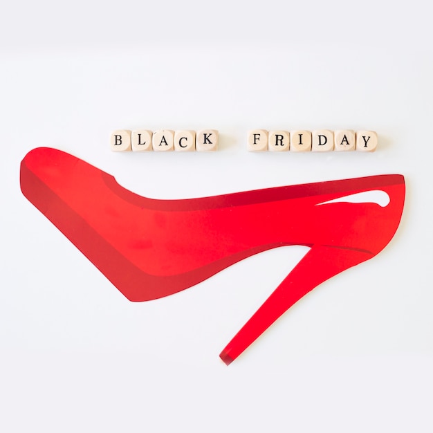 Free photo black friday inscription on cubes with paper shoe