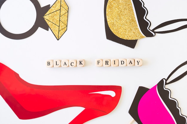 Free photo black friday inscription on cubes with red paper shoe